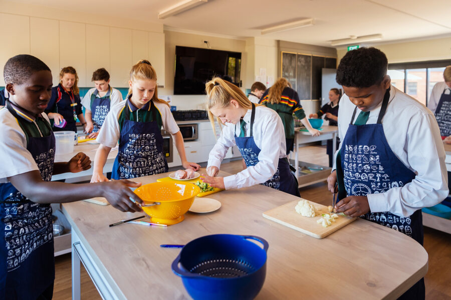Middle School Students in the kitchen preparing food