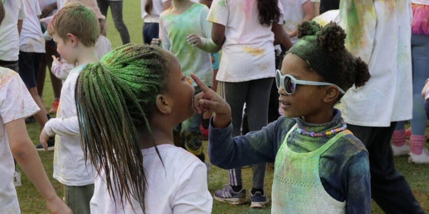 Two girls looking at each other after the colour fun run
